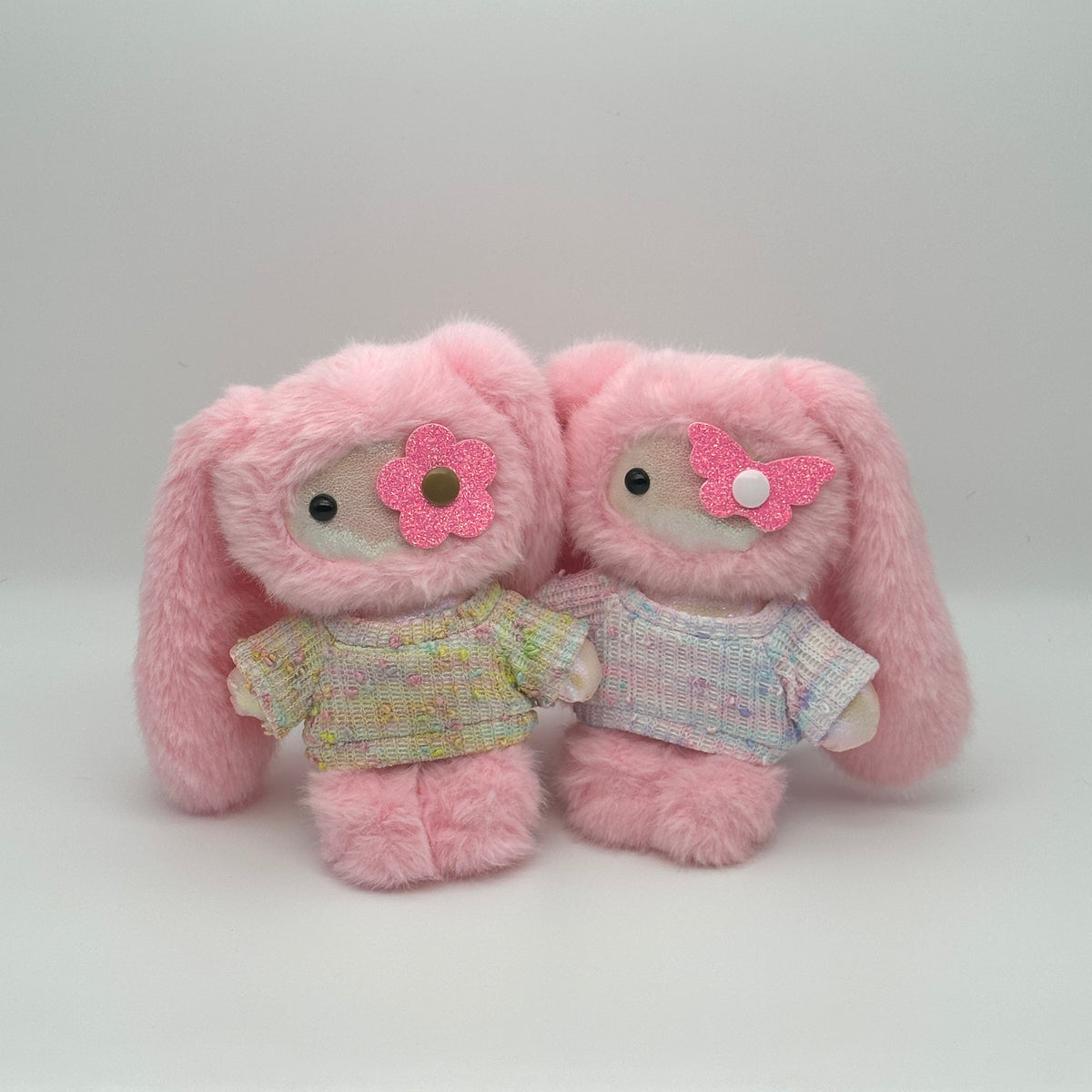 Two pastel sprinkle knit doll sweaters in yellow and white, compatible with all JUJU collection.
